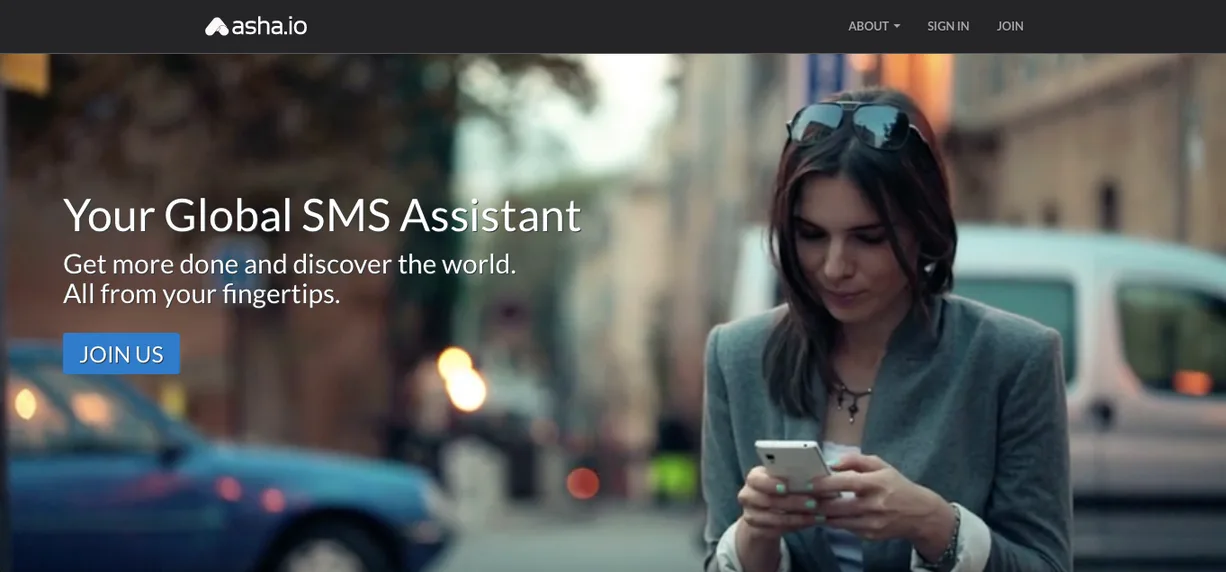 Asha.io hero 'Your Global SMS Assistant' with a photo of a woman looking at her phone.