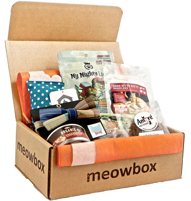 Open cardboard box labelled meowbox filled with cat toys and treats.