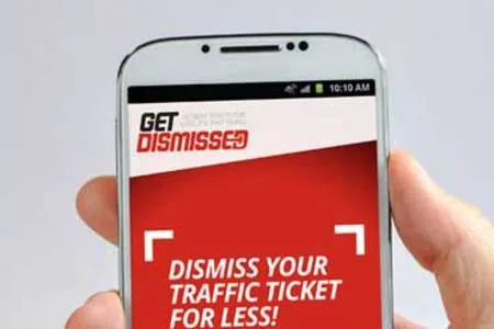 Hand holding a Samsung phone showing a red Get Dismissed screen 'Dismiss your traffic ticket for less!'.