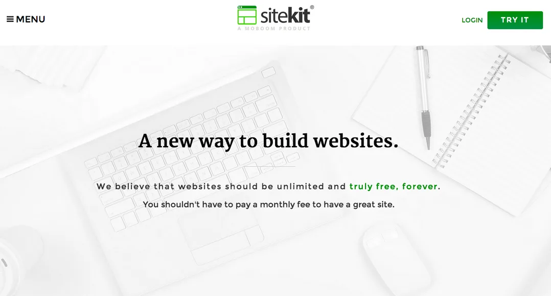 Homepage 'A new way to build websites.' on a white desk background.
