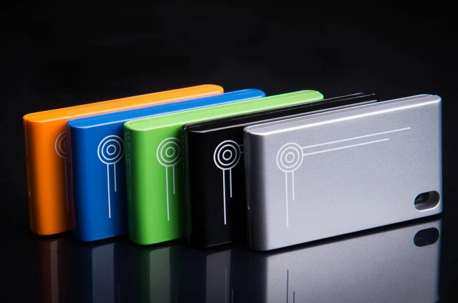 Product photo of five metal key fob devices in orange, blue, green, black and silver.