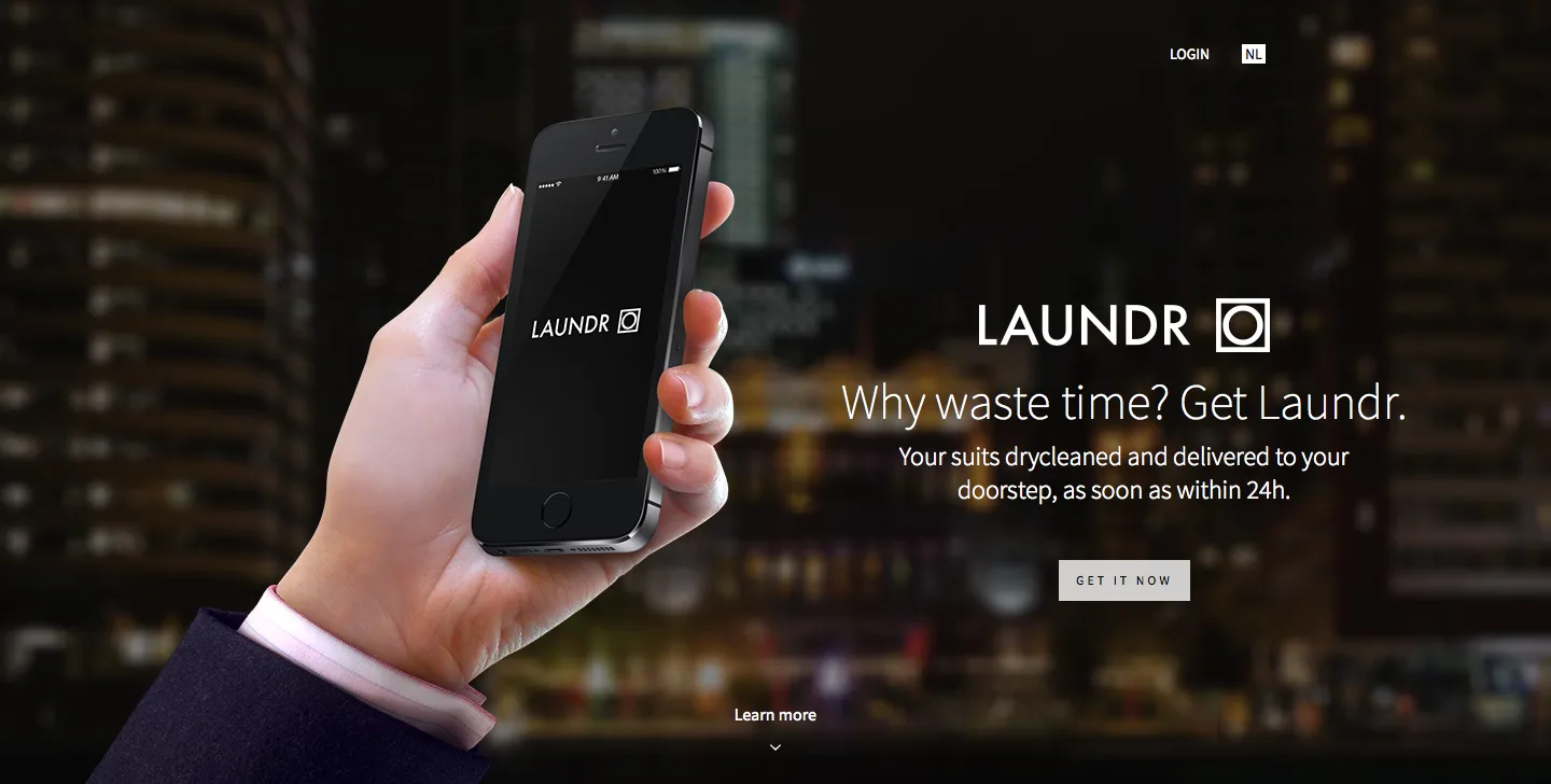 Dark landing page with a hand holding a phone showing the Laundr app and the text "Why waste time? Get Laundr.".