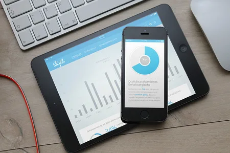 Photo of an iPhone and iPad on a desk showing an app with a donut chart.
