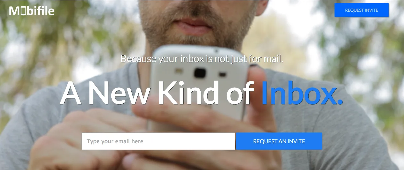 Landing page headlined "A New Kind of Inbox." over a close-up of a man holding a phone, with an email form.